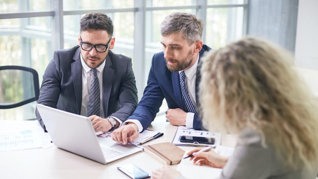 Two mortgage professionals reviewing annual account records