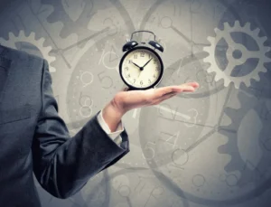 Businessman with an alarm clock waiting on a delayed mortgage license approval