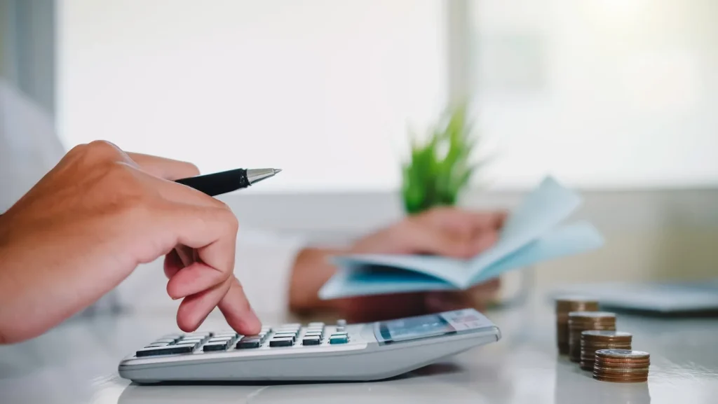Mortgage broker calculating NMLS renewal fees and licensing costs for next year’s compliance budget